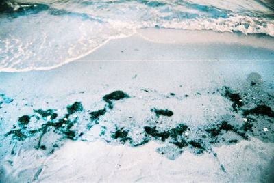 High angle view of footprints on sandy beach