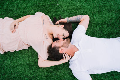 High angle view of woman relaxing on field