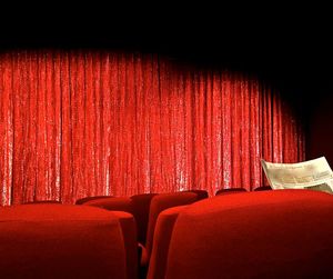Red chair against curtain