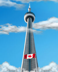 Low angle view of flag tower against cloudy sky