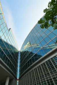 Low angle view of modern buildings against blue sky