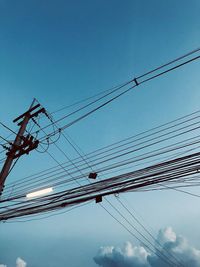 Low angle view of electricity pylon against sky