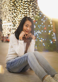 Portrait of young woman sitting at home