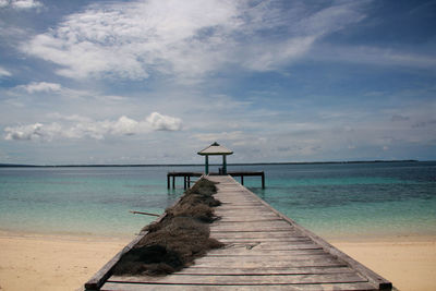 Pier over sea against sky