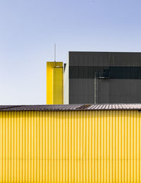 Yellow built structure against clear sky