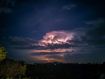 Silhouette landscape against sky at night