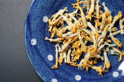 Directly above shot of dry squash flowers in plate