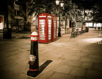 Red telephone booth at night