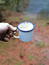 Hand holding coffee cup