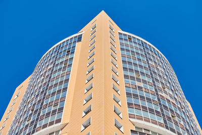 Low angle view of modern building against clear blue sky