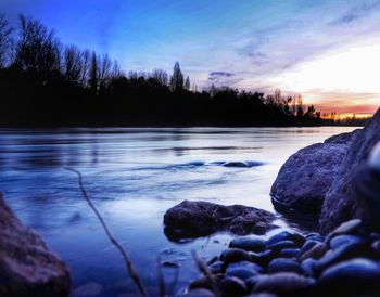 Scenic view of frozen lake against sky during sunset