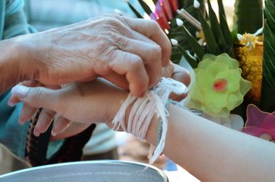 Close-up of man holding flower