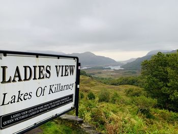 Information sign on landscape against sky