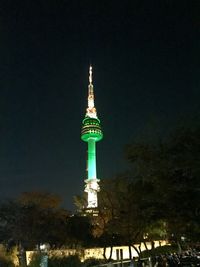 Low angle view of communications tower against sky at night