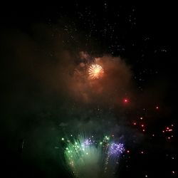 Low angle view of firework display at night