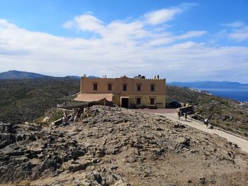 House on mountain against sky