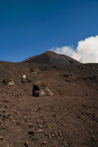 Scenic view of desert against clear blue sky