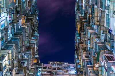 High angle view of illuminated buildings in city at night