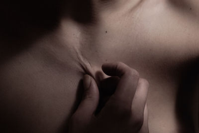 Close-up of shirtless woman pinching her skin