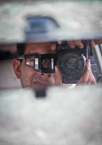 Close-up of young man using mobile phone