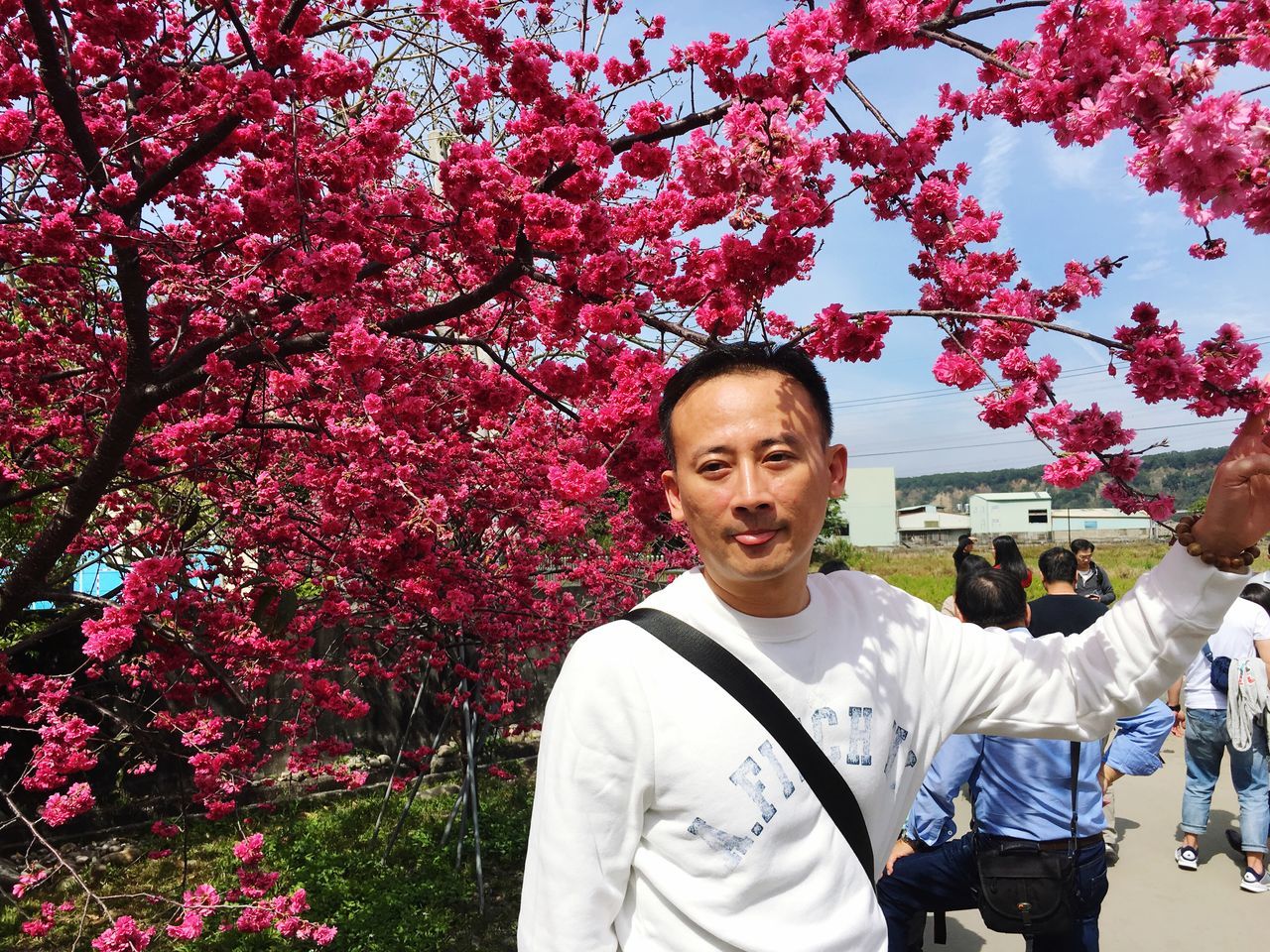 lifestyles, person, casual clothing, leisure activity, tree, looking at camera, portrait, smiling, front view, happiness, standing, young adult, park - man made space, elementary age, waist up, childhood, growth