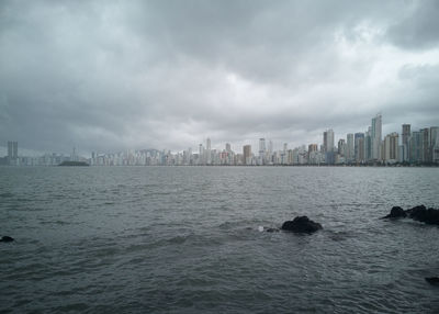 Skyscrapers after the storm on the beach. storm colors