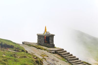 View of lighthouse on mountain against sky