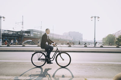 Man riding bicycle on street in city