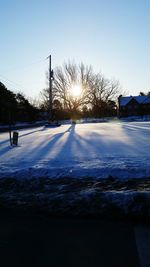 Sun shining through snow covered road