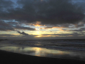 Scenic view of sea against dramatic sky