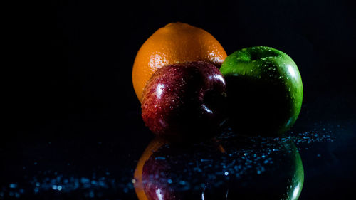 Close-up of apple against black background