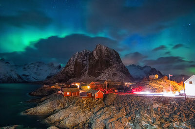 Panoramic view of illuminated mountain range against sky at night