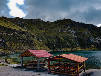 Gazebo on table by mountains against sky