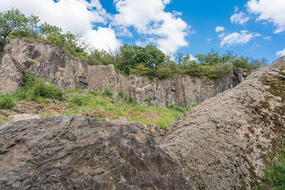 Low angle view of rocks on landscape against sky