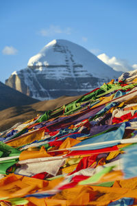 Low angle view of people on mountain against sky