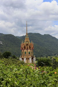 Temple by building against sky