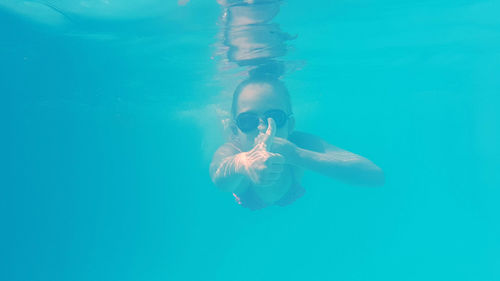 Girl swimming underwater in pool