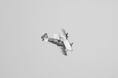 Low angle view of helicopter flying against clear sky