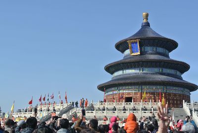 Crowd at historic temple of heaven against clear sky