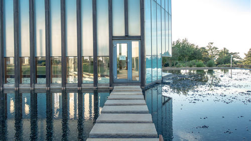 Scenic view of river by building against sky