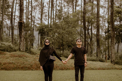 Full length of a smiling young man in forest