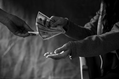 Close-up of hand holding cigarette