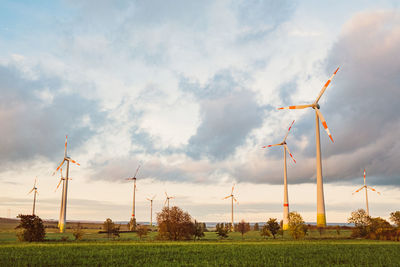 Windmill on field against sky