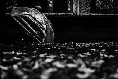 Close-up of broken glass on field