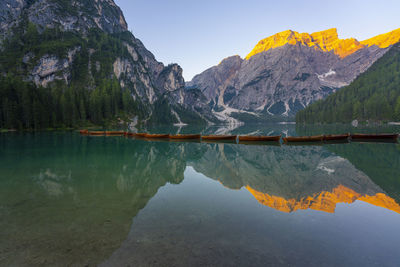 Scenic view of lake by mountains against sky