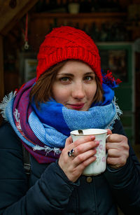 Close-up portrait of young woman holding ice cream