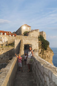 Woman standing on fort against the sky