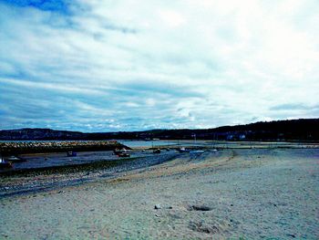 Scenic view of sea against cloudy sky