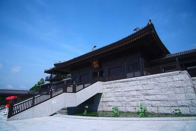 Low angle view of built structure against blue sky