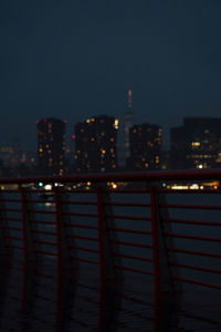 Illuminated buildings against sky at night